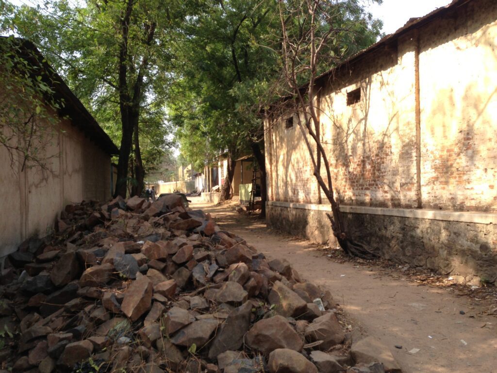 Sunlit alley with scattered stones