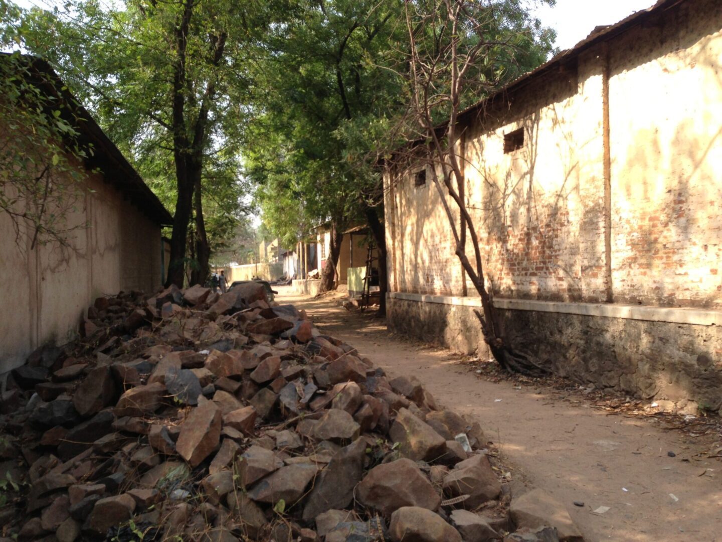 Sunlit alley with scattered stones