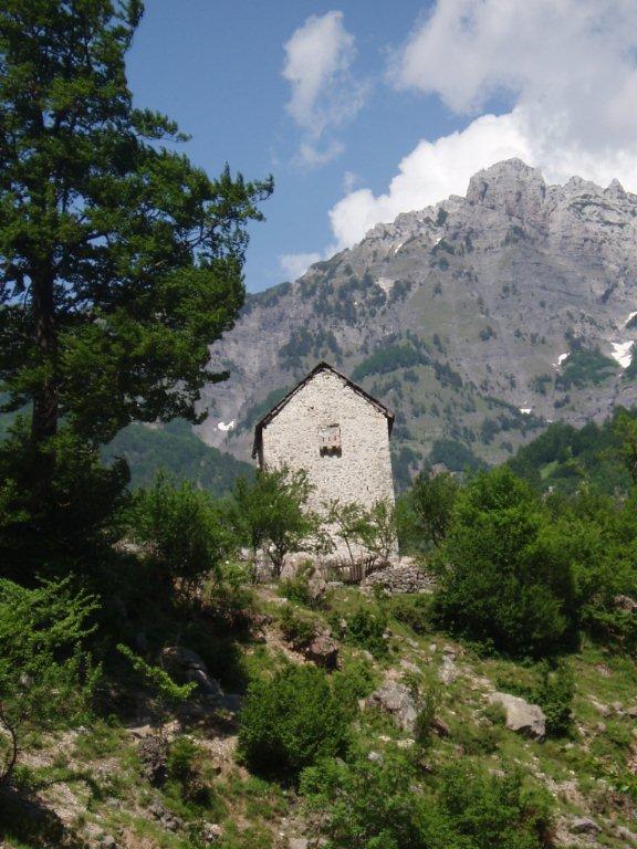 Stone house amidst alpine scenery