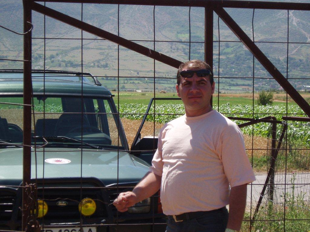 Individual posing outdoors by a jeep