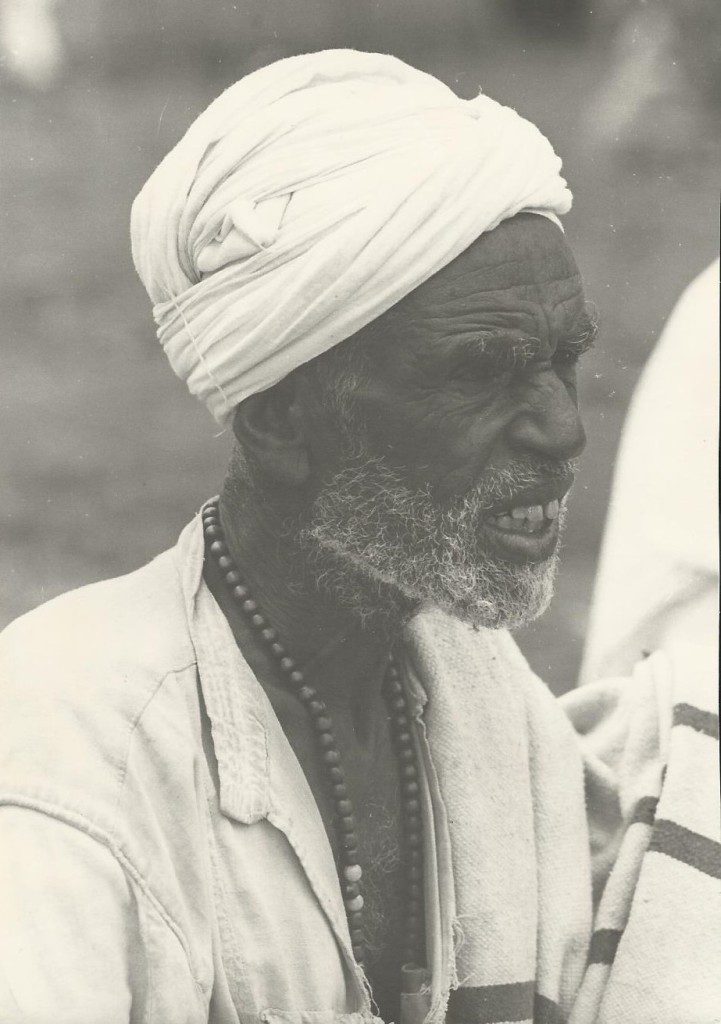 Elderly man wearing a turban and beads
