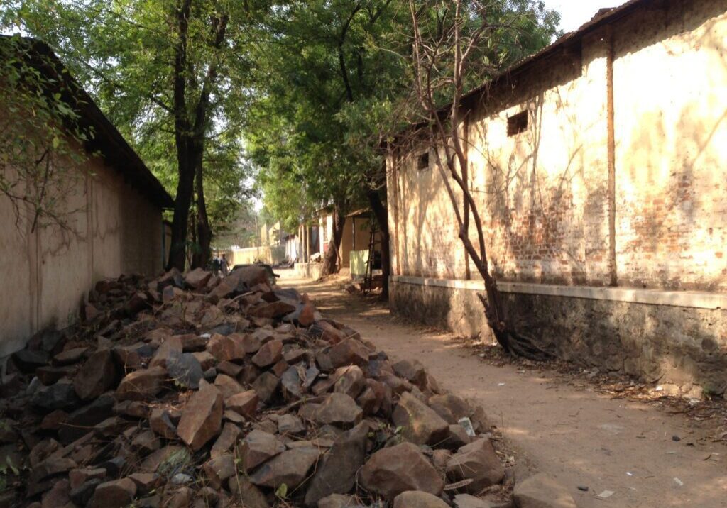 Sunlit alley with scattered stones