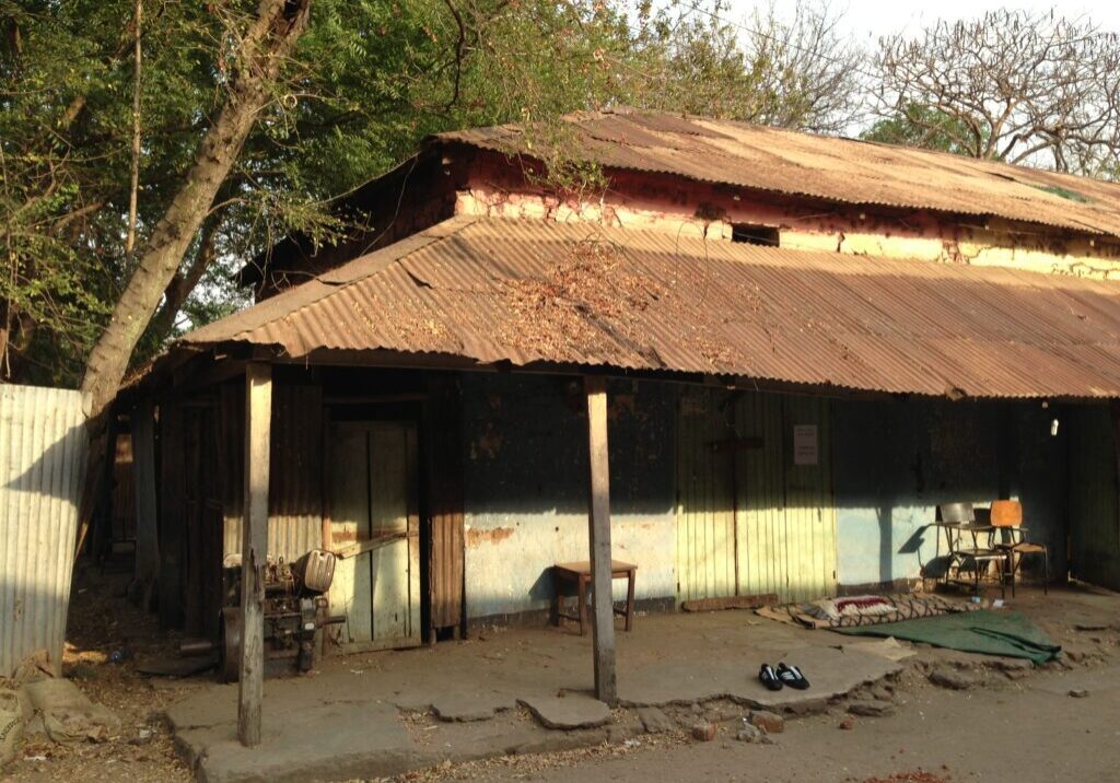 Weathered building surrounded by trees