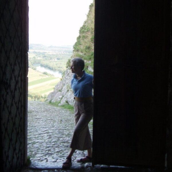 Woman in doorway with scenic background